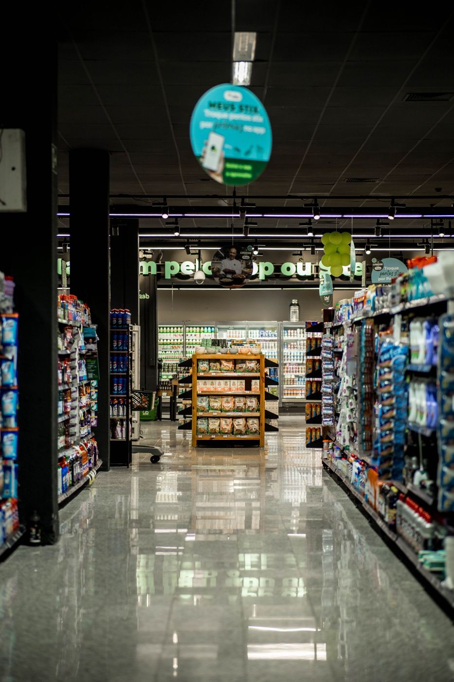 A supermarket aisle with shelves of packaged goods.