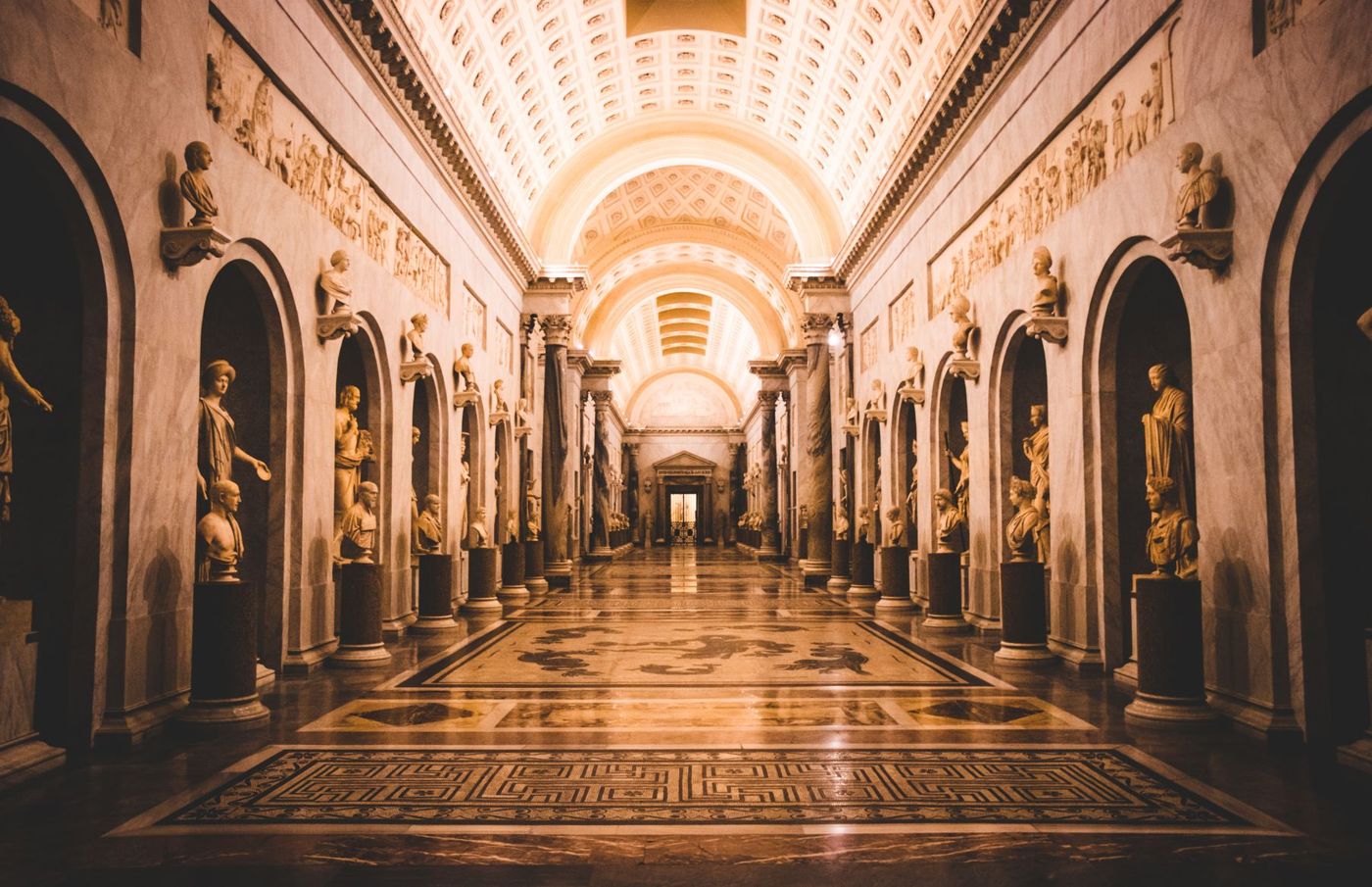 A long gallery hall with arches.